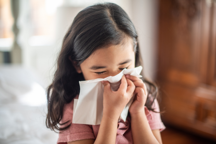 Girl Blowing Her Nose with a Tissue due to Nosebleed