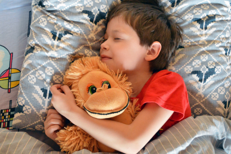 Child in bed sleeping and snoring