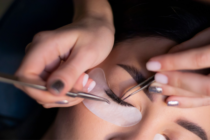 woman gets eyelash extensions during a beauty treatment