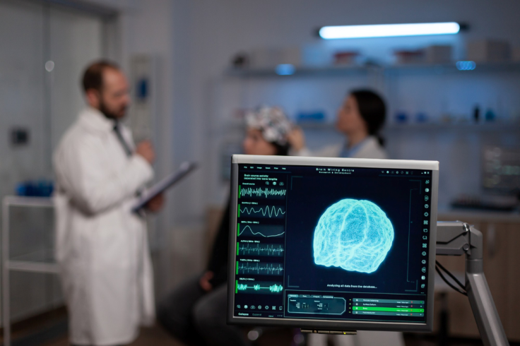 doctor scanning brain using medical device