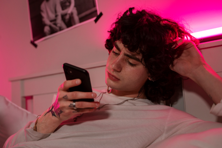young person doomscrolling on social media