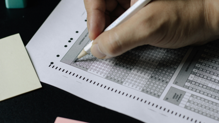 Student Writing on Paper During an Examination
