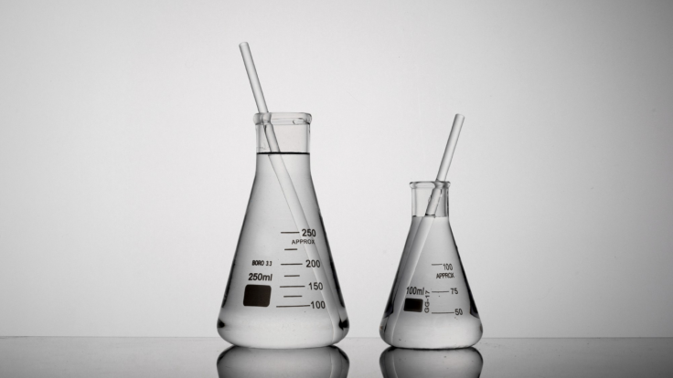 Closeup shot of tubes inside erlenmeyer beakers